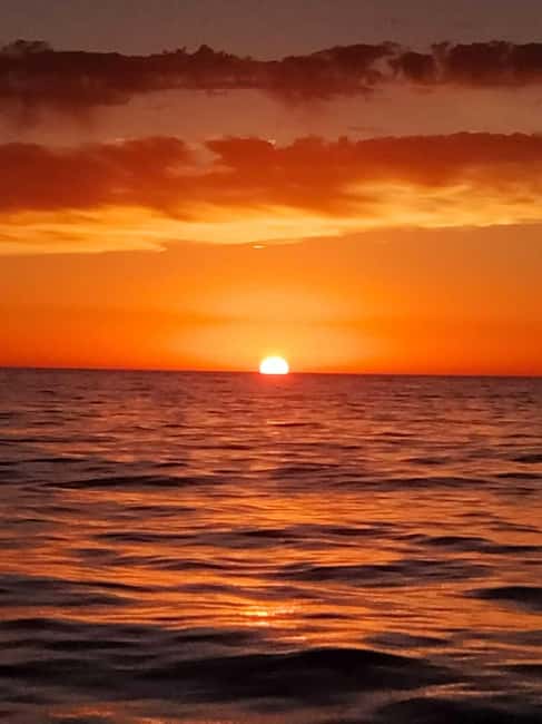 From Denia: Catamaran Trip with Sunset Option - Sunset from Dénia: the Costa Blanca mountains at golden hour