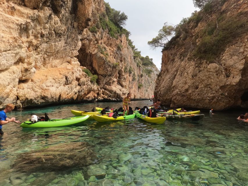 Granadella: Caló, Cova Llop Marí, and Ambolo Kayak Trip - What you actually get included: masks, waterproof gear, and the end drinks